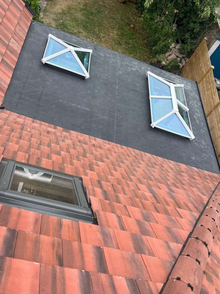 This is a photo taken from the roof ridge looking down a tiled pitched roof on to a flat roof. Works carried out by TRP Roofing Pocklington