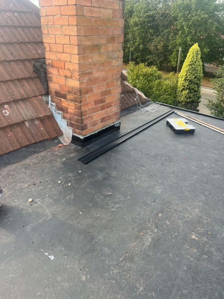 This is a photo of a flat roof which has just been repaired, there is also a chimney stack and some leadwork has also been dressed. Works carried out by TRP Roofing Pocklington